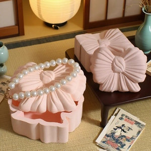 Pink bow storage box resin mold for jewelry organization in a traditional Zen setting