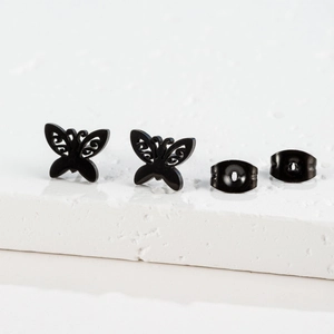 Macro view of French vintage butterfly stud earrings set in matte black stainless steel