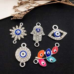 Evil Eye and Hamsa Hand jewelry charms with blue enamel and sparkling crystals