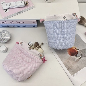 Macro view of quilted heart pattern and floral lining on drawstring storage bags