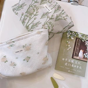 Detail view of floral makeup bags with simple wish embroidery and premium metal zippers
