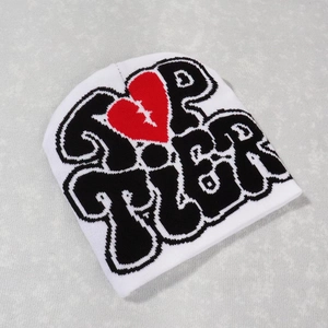 White Y2K knit beanie with black UP TIER lettering and red broken heart graphic