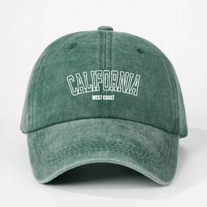 Detailed view of white California letter print on vintage green washed cotton baseball cap