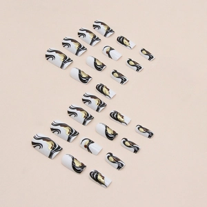 Square long press-on nails with black wavy stripes and gold glitter accents on white base