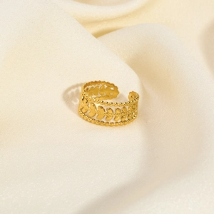 Detailed shot of vintage gold leaf texture and beaded edges on a stainless steel ring