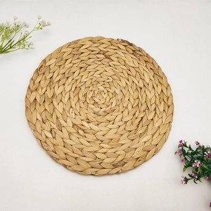 Handwoven water hyacinth round placemat with natural heat-resistant spiral weave pattern
