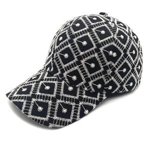 Classic black baseball cap featuring intricate white geometric embroidery on the front panel