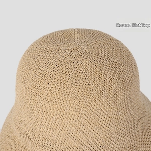 Close-up of the dense and uniform round top weave on a beige breathable knit bucket hat