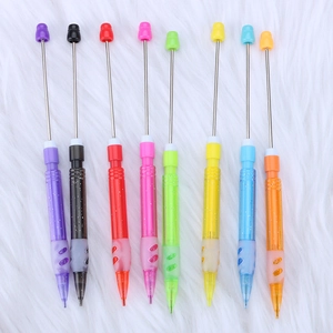 Set of eight colorful beadable mechanical pencils on white plush background for students