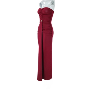 Detail of ruched bodice and side drape on a burgundy strapless floor-length dress