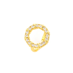 Macro detail of gold plated zircon ring featuring a classic cross X design and clear stones