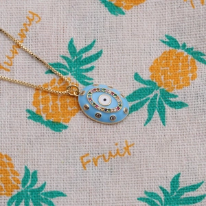Detailed shot of gold plated evil eye pendant necklace with colorful zircon stones