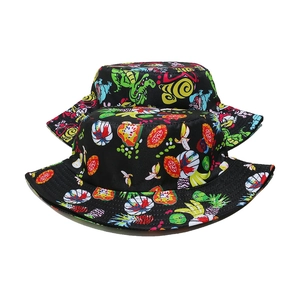 Detail of colorful dinosaur and fruit print patterns on black cotton bucket hats