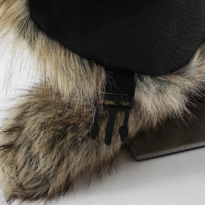 Detail of faux leather trapper hat featuring thick plush lining and adjustable buckle strap
