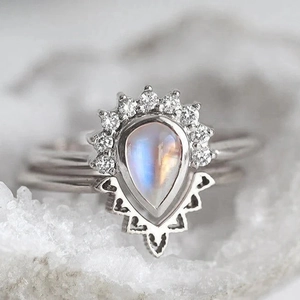 Vintage style moonstone ring set with pear-shaped gemstone and geometric silver hollow details
