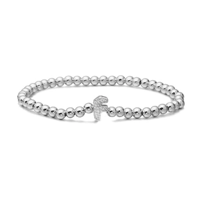 Macro detail of silver beaded bracelet featuring a micro-paved cubic zirconia letter F