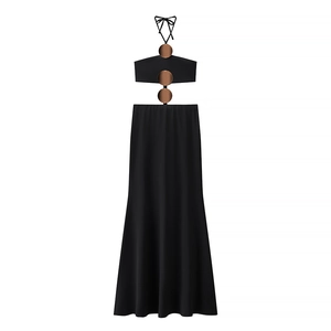 Detail of black halter maxi dress featuring waist cut-outs and brown circular accents
