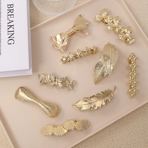 Set of nine golden spring hair clips with pearls, stars, and floral butterfly designs