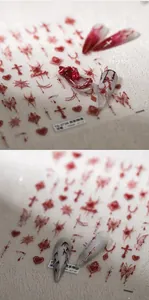 Detailed view of gothic nail stickers featuring red cross and spider web patterns