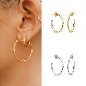 Irregular textured C-shape hoop earrings in gold and silver finish for women