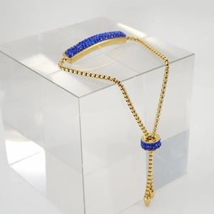 Detailed close-up of adjustable 18K gold-plated bracelet with pavé blue zircon bar