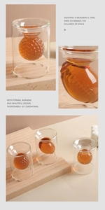 Detail view of creative double-wall glass with amber rugby-shaped inner layer