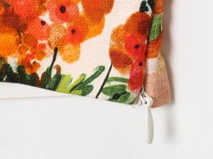 Macro shot of invisible zipper detail on orange floral fabric with woven texture
