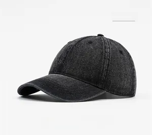 Detail of black washed denim baseball cap featuring six-panel crown and curved brim texture