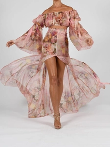 Detail of pink floral two-piece set featuring off-shoulder top and high slit maxi skirt