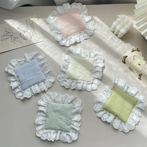 Five-piece pastel lace coasters with dot pattern in French country style on desk