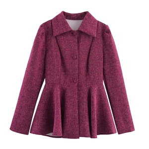 Detailed close-up of fuchsia tweed jacket with a cinched waist and ruffled peplum hemline