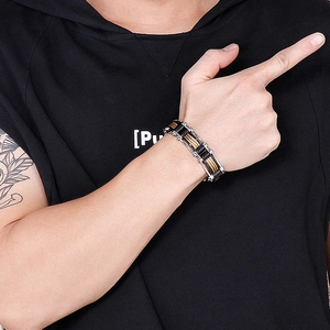 Close-up of men's stainless steel cable chain bracelet in gold and silver finish