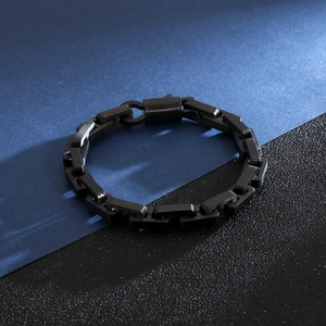 Close-up of black matte titanium steel chain bracelet with industrial flat link design