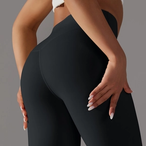 Close-up of high-waist black yoga leggings showing compression fabric and lift fit