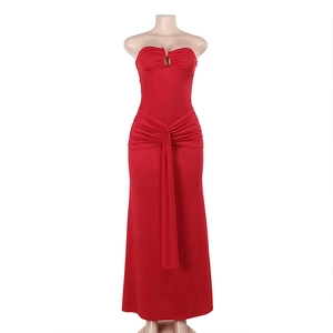 Close-up of red bodycon tube dress featuring V-neck detail and draped waist pleats