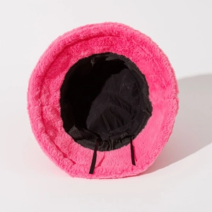 Detail of bright pink faux fur bucket hat with black inner lining and adjustable drawstring