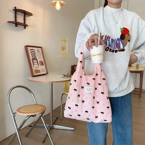 Detail of pink puffy tote bag with animal texture print in a cozy cafe setting