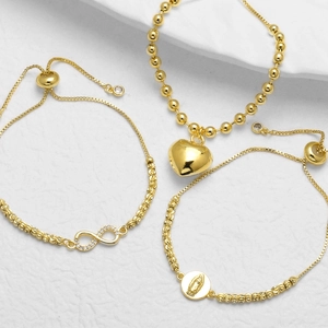 Handmade 18k gold plated bracelet set with heart, infinity, and Virgin Mary pendants