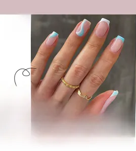 Detail of French blue and white wave line press-on nails on hands with gold rings