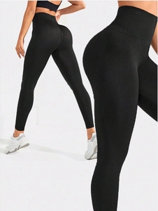 Detail of high-waisted ribbed waistband on black yoga leggings with tummy control