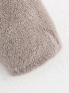 Close-up of soft faux fox fur material texture in taupe for fashionable winter coat