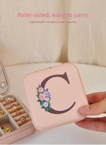 Pink PU jewelry box with floral C letter detail and multi-slot interior rings storage