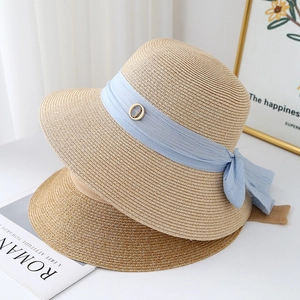 Elegant wide-brim straw sun hat with blue chiffon ribbon for summer beach vacation