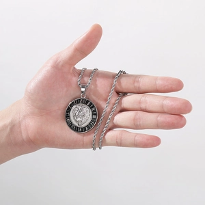 Macro detail of silver lion head pendant with roman numerals on a twisted chain