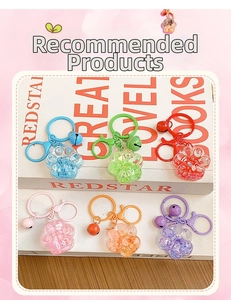 Detail of DIY cat paw liquid sand keychains in six colors on white book background