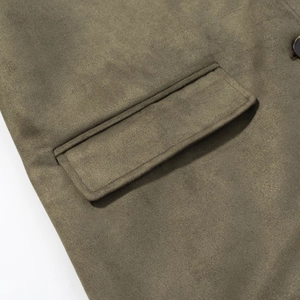 Detail of premium suede blazer featuring olive green flap pocket and fine stitching