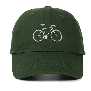 Detail of white bicycle embroidery and reinforced stitching on dark green cotton cap