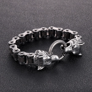 Detailed macro view of retro bike chain bracelet with wolf head clasps and knurled texture