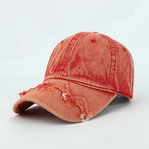 Vintage washed orange baseball cap with distressed frayed edges and cotton fabric