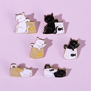 Detailed view of six cute enamel cat pins with fish icons and paper bags on purple base